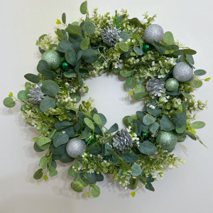 Christmas wreaths with seasonal foliage, cones, orange and cinnamon tied with a handmade bow