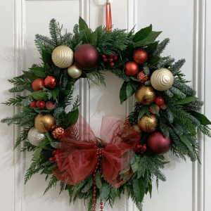 christmas conifer wreath with red, gold and champagne baubles and red bow
