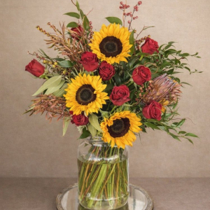 Autumnal display with sunflowers, roses, birch, crocosmia and foliage