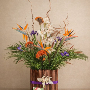 Large reception arrangements, strelitzia, iris, celosia, orchids in a bamboo decorated vase