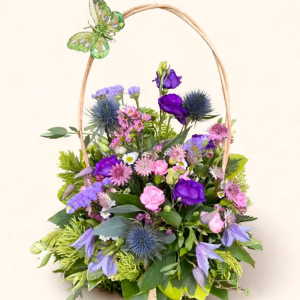 Basket arrangement with seasonal blooms with butterfly