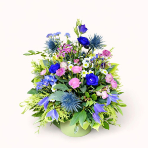 Hat box arrangement with seasonal blooms