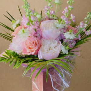 bouquet of light and darker pink flowers in pink bag