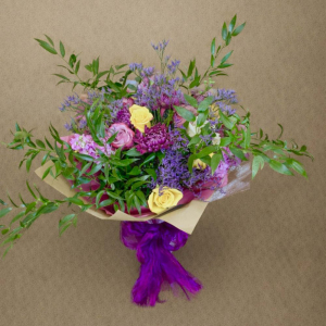 bouquet of multicoloured flowers wrapped by dark purple ribbons