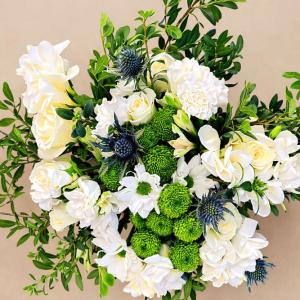 bunch of white flowers supported by green foliage