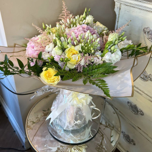 yellow roses with pink flowers within green foliage