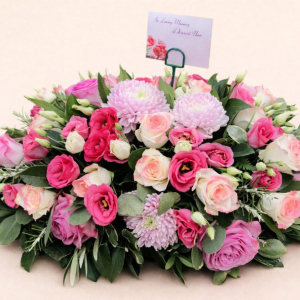 cream and red roses with pink flowers on green foliage