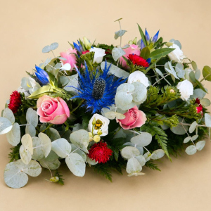 a beautiful arrangement of eucalyptus, thistle, rose, lisianthus, and aster
