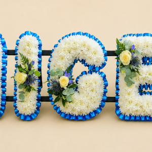 Bespoke letter tribute. Chrysanthemum base with blue ribbon, gentiana, rose, thistle, olive, leatherleaf and eucalyptus sprays