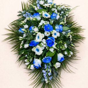 spray of blue and white flowers on bed of green foliage
