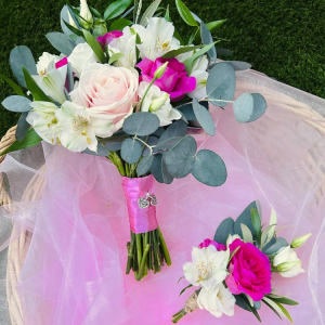 pink and white roses in posy sitting on pink lace
